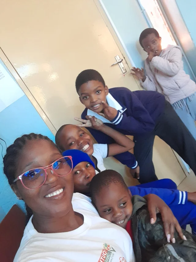 A staff member and children sharing a moment together at the centre.