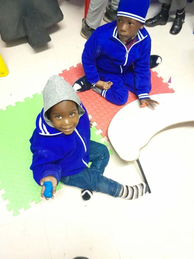 Children exploring floor-based creative play materials.